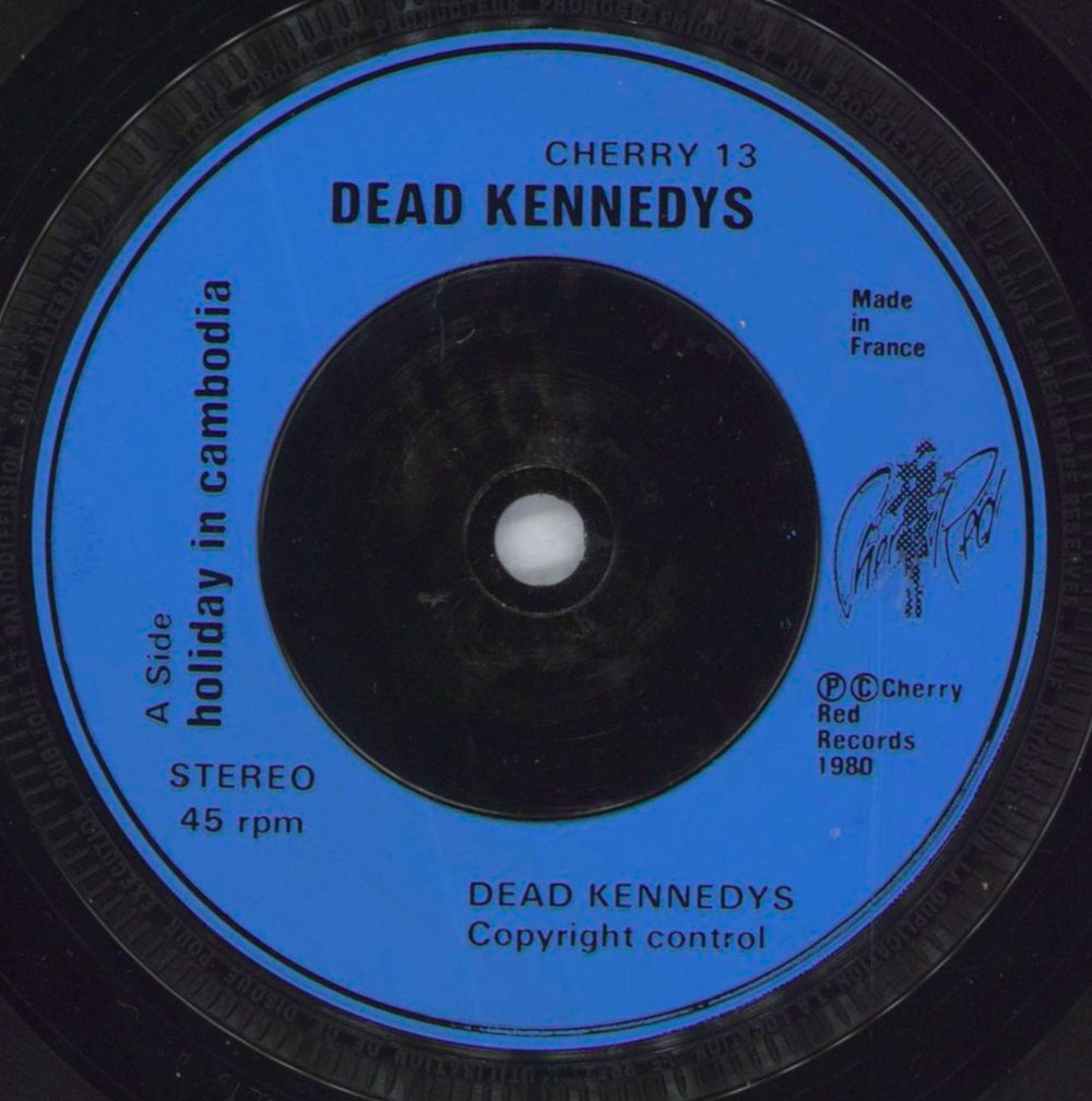 Dead Kennedys Holiday In Cambodia - Plane Sleeve + Blue injection UK 7" vinyl single (7 inch record / 45) DKN07HO735562